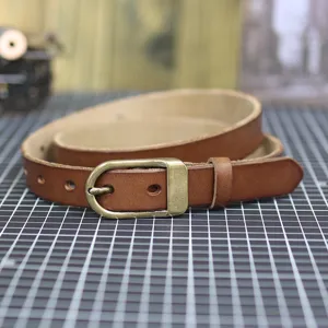 Brown leather thin belt for women, vintage metal buckle, versatile casual waist accessory.