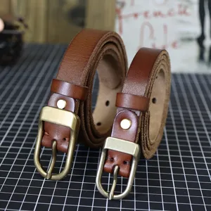 Brown genuine leather thin belt for women, narrow vintage style jeans dress strap detail.