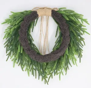 Detailed view of Norfolk pine Christmas wreath with jute rope bow hanging