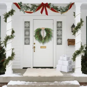 Detailed view of a lush Norfolk Pine Christmas wreath hanging on a white front door