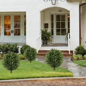 Detailed view of three artificial topiary shrubs decorating a modern house garden lawn.