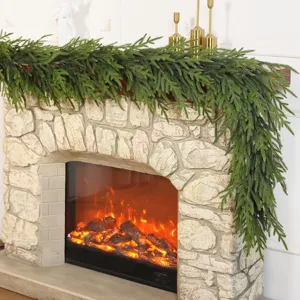 Realistic 13-fork Norfolk pine garland draped over a cozy stone fireplace mantel decor.