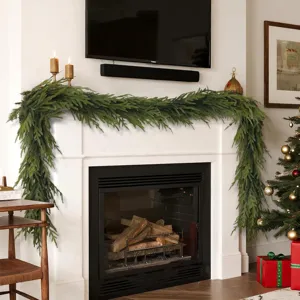 Realistic 13-fork Norfolk Pine garland draped over a white fireplace for Christmas.
