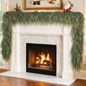 Realistic Norfolk pine garland draped over a white fireplace for Christmas decor.