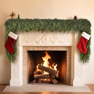 Lush green Norfolk pine garland draped over a warm fireplace with red stockings
