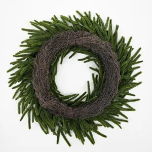 Detailed back view of a Christmas wreath featuring green pine needles and a brown woven base