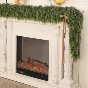 Lush artificial Norfolk pine garland draped over a white festive fireplace mantel