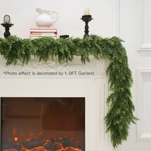 Realistic Norfolk pine garland draped on a white Christmas fireplace mantel.