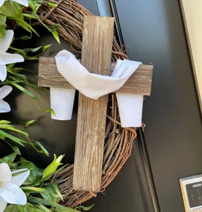 Rustic Easter grapevine wreath with wooden cross and white lilies for front door decor