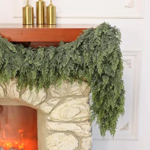 Realistic Norfolk pine garland draped over a cozy fireplace mantle for holiday decor.