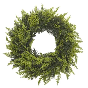 Detailed view of a realistic green cedar wreath with soft-touch foliage for home decor