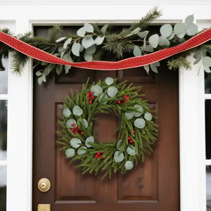 Detailed view of Christmas pine and eucalyptus wreath with berries on a front door