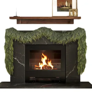 Realistic Norfolk pine artificial Christmas garland draped over a cozy fireplace mantel.