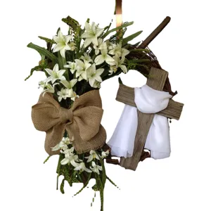 Easter grapevine wreath with white lilies, burlap bow, and wooden cross door decoration.