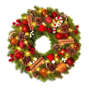 Close-up detail of festive Christmas wreath with warm LED lights and pine cones