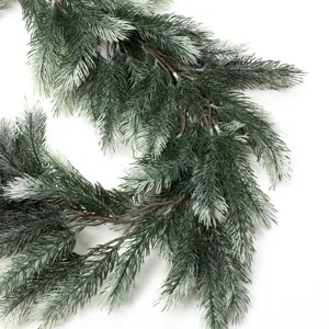 Close-up detail of artificial frosted pine needle garland for festive Christmas decor