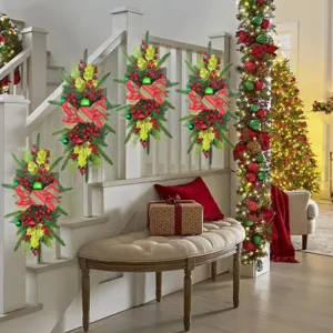 Festive Christmas teardrop swags decorated with red berries and bows on a staircase