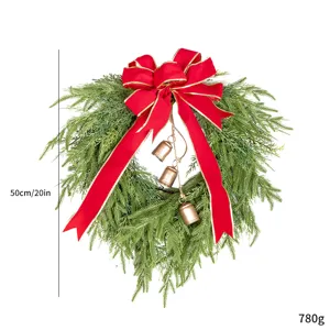 Detailed view of Christmas wreath showing 50cm size and weight with red ribbon bow