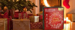 LED Christmas wreath lights in decorative gift box shown in festive home setting
