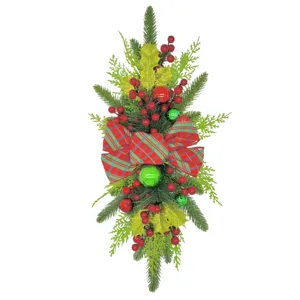 Detailed view of Christmas teardrop swag with red plaid bow and green pine branches