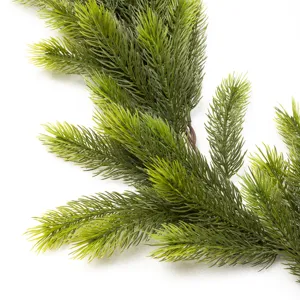 Close-up of realistic green artificial pine needle branches for Christmas decor