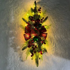 Festive Christmas teardrop swag with warm LED lights, red berries and plaid bow