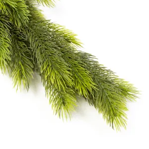 Close-up detail of realistic green artificial pine needles for Christmas table decoration.