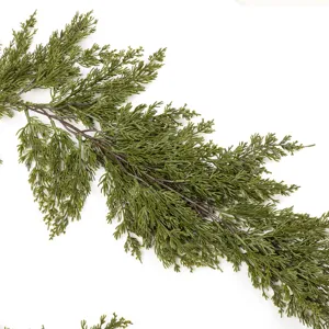 Detailed close-up view of realistic artificial green pine needles and cedar branches