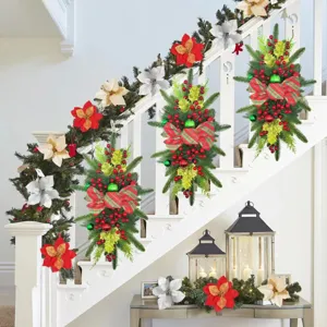 Christmas teardrop swag with red berries and bow on white staircase railing