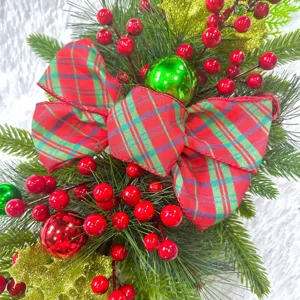Close-up detail of festive Christmas teardrop swag with red berries and green pine needles