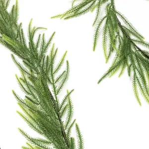 Close-up detail of realistic artificial pine needle branches for Christmas decor