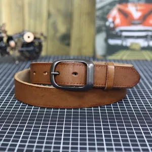 Detail shot of retro men's brown leather belt with metal pin buckle and neat stitching.