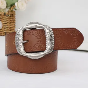 Retro brown leather belt with ornate silver metal buckle, detailed embossed floral pattern.