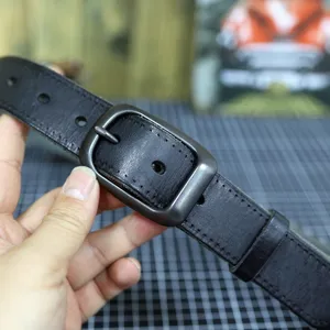 Vintage genuine leather belt for men with stylish metal pin buckle and casual jeans design.