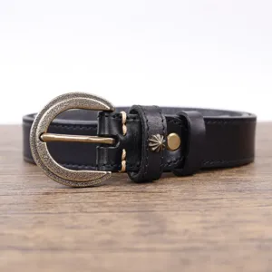 Detailed view of a vintage black genuine leather belt with ornate brass buckle and metal stud.