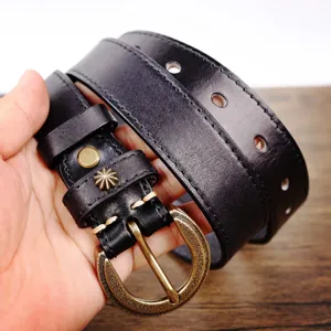 Black genuine leather belt featuring a vintage brass round buckle and retro star stud detail for women.