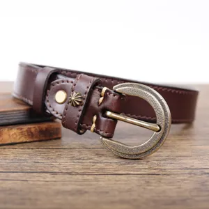 Close-up of retro genuine leather belt, dark brown strap with vintage metal buckle details.