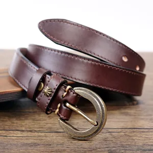 Close-up detail shot of retro brown genuine leather women belt with vintage metal buckle