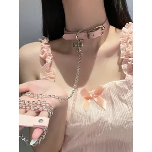 Pink PU leather choker necklace with cute bone pendant and metal chain leash for women fashion.