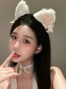 Fluffy white cat ear headband and lace choker detail shot, soft plush cosplay hair accessory.
