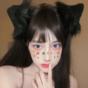 Black fluffy cat ears headband detail view, cute Japanese style plush animal hair clip accessory.