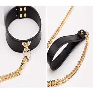 Black leather choker necklace featuring gold chain hardware and stylish gothic fashion design.