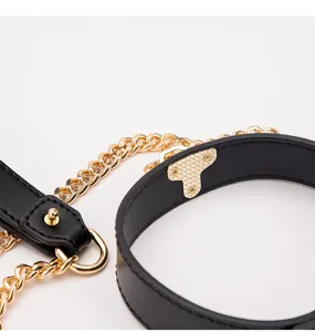Detailed view of a stylish black leather choker necklace with gold chains and secure metal clasp.