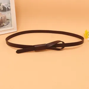 Close-up of the elegant knot design on a dark brown skinny cowhide leather belt for women
