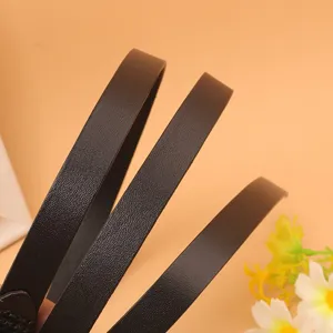 Close-up detail of a slim dark brown cowhide leather belt showing fine texture and edges.