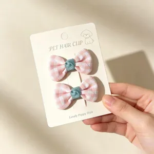 Handmade pink checkered pet bow hair clips, cute puppy accessories for small dogs detail.