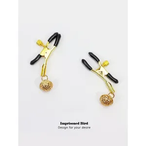 Gold metal nipple clamps with black rubber tips and ringing bells for adult pleasure games.