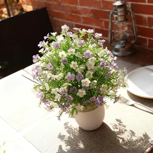 Detailed close-up view of artificial Milan baby's breath flowers in a white ceramic pot