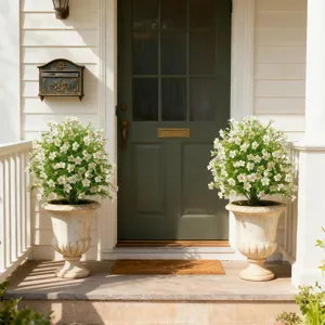 Artificial Gypsophila silk plants in decorative vintage pots flanking a green front door.