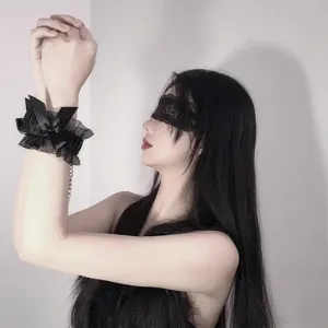 Black lace blindfold and bow cuffs detail shot, exquisite bondage accessory for romantic nights.